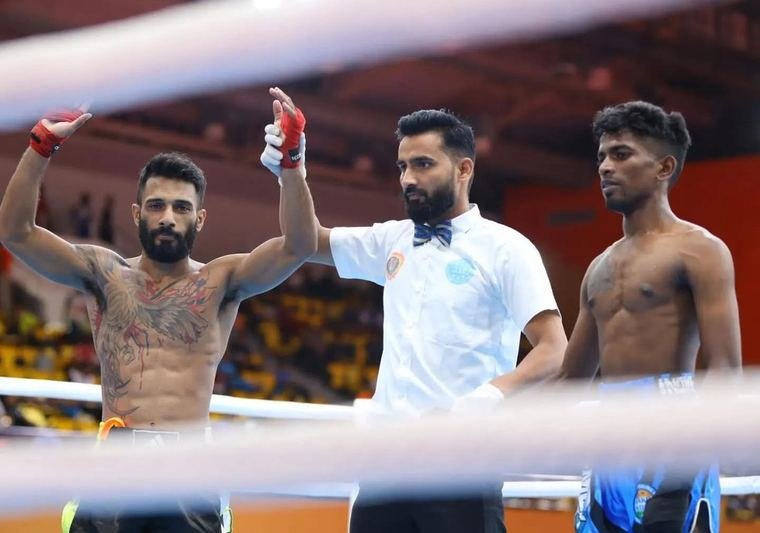 Fighter's hand raised in victory after a bout