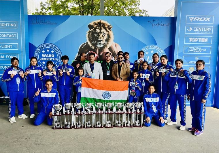 Young athletes with trophies and the Indian flag at a WAKO event